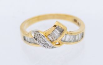 A diamond and 18ct gold ing, comprising channel set tapered baguette diamonds and claw set round