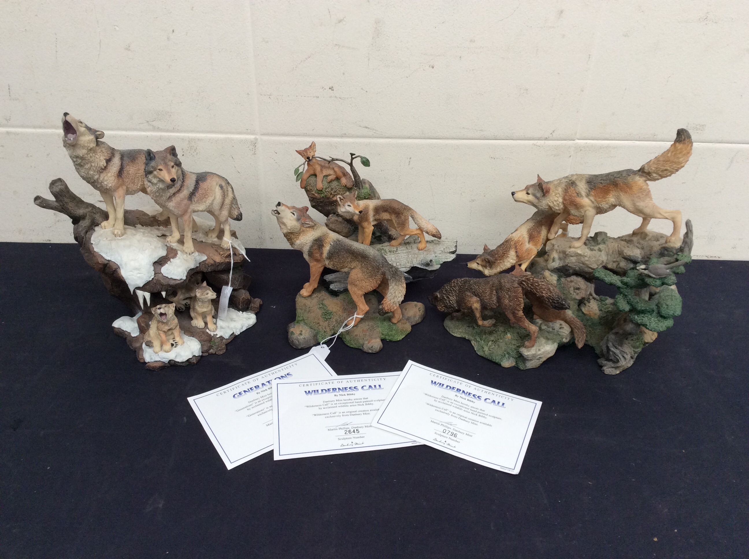 Three resin figures of wolves "Wilderness Calls" Danbury mint, all with certificates.