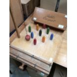 A table croquet set by F.H. Ayres Ltd, in box, along with a table skittles set, multicoloured