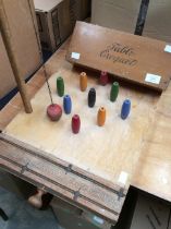 A table croquet set by F.H. Ayres Ltd, in box, along with a table skittles set, multicoloured