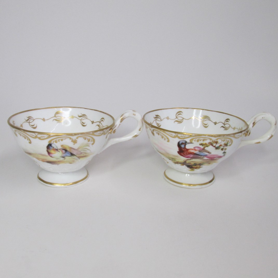 Two teacups hand painted with exotic birds in flight,  pattern 3/608 by John Randall attributed to