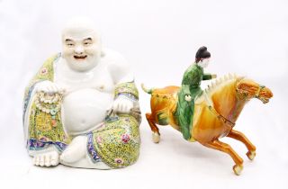 A large Chinese early 20th Century porcelain Buddha along with a Chinese warrior on horseback.