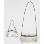 An Edwardian silver oblong shaped ladies purse, elaborate engraved foliage design and green velvet