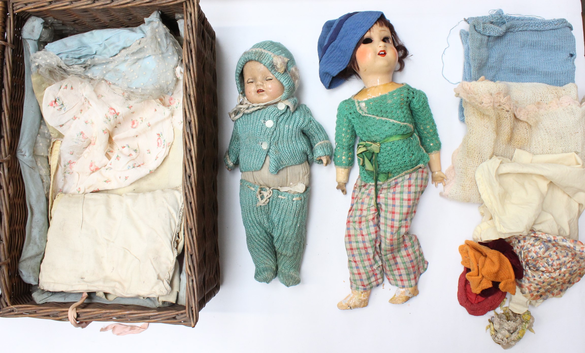 Dolls: A pair of composition dolls with assorted clothing and accessories. Dolls have sustained