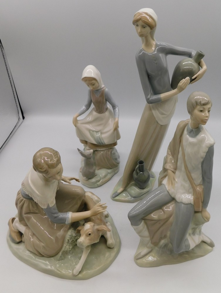 A collection of four Lladro figures