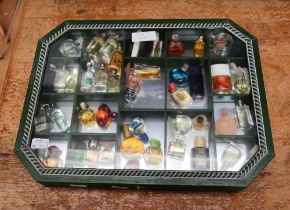 A collection of thirty-nine  miniature and sample perfume bottles, comprising vintage and later