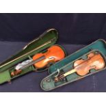 Two early 20th Century violins in cases with bows.