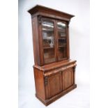 A Victorian glazed display cabinet of two glazed doors above a single drawer and two further