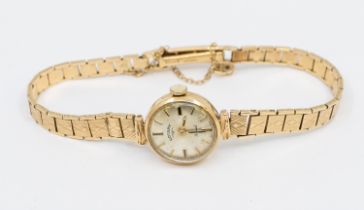 A ladies 9ct gold Rotary wristwatch, silvered round dial, applied baton makers, case apporox 16mm,