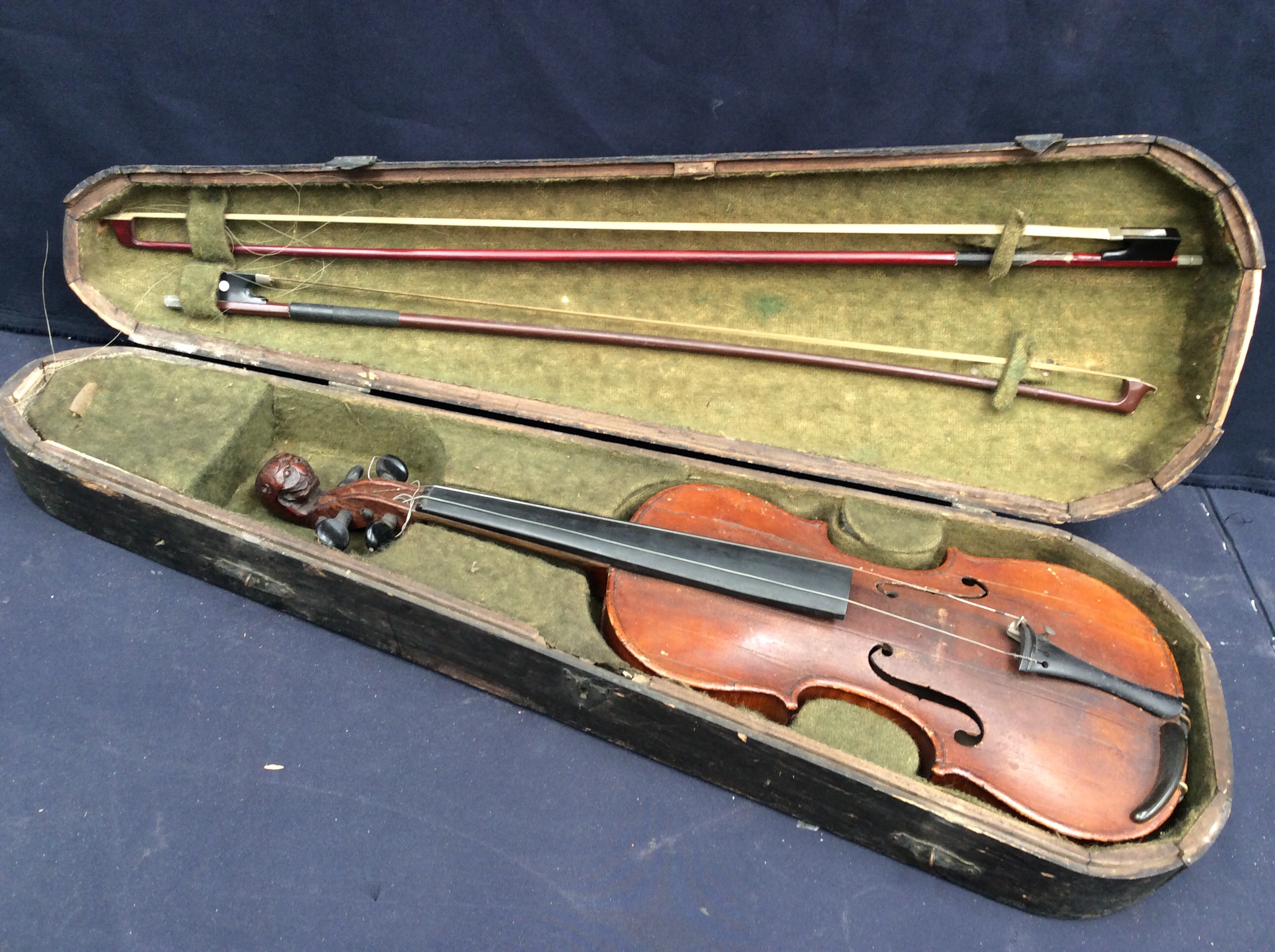 A 19th Century violin in case with Tyroleon lion scroll, with two bows, one named Roth Glasser.