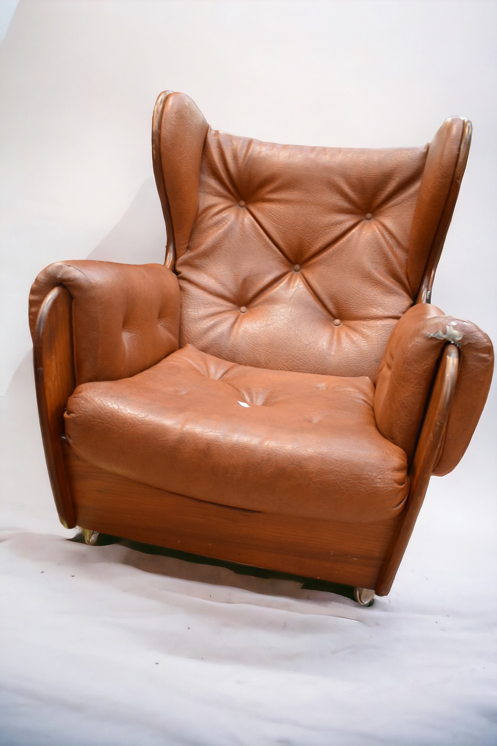 An early 1970s teak and leatherette button back lounge armchair on castors. - Image 2 of 6