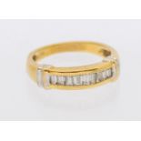 A diamond and 18ct gold ring, comprising a row of channel set baguette cut diamonds, white gold