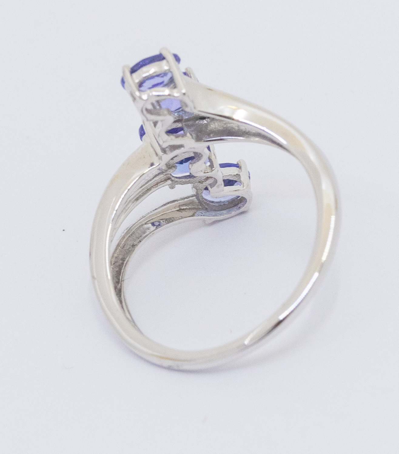 A tanzanite and 9ct white gold ring, comprising a row of five oval mixed cut stones, claw set to a - Image 2 of 2