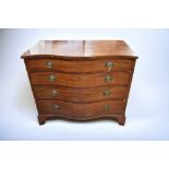 A Georgian serpentine-fronted chest of drawers in mahogany, with condition issues