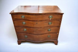 A Georgian serpentine-fronted chest of drawers in mahogany, with condition issues