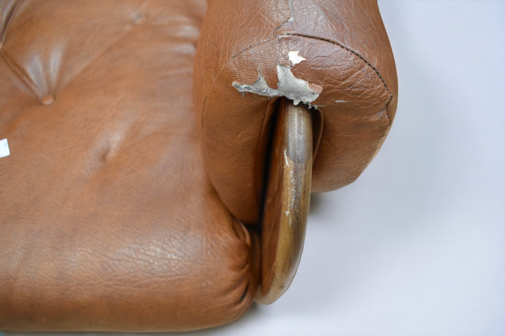 An early 1970s teak and leatherette button back lounge armchair on castors. - Image 3 of 6