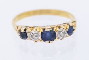 A sapphire and diamond five 18ct gold ring, width approx 4mm, size O1/2, unmarked assessed as 18ct