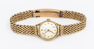 Omega- a ladies vintage 9ct gold Omega wristwatch, comprising a round signed silvered dial with gilt