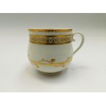 A Derby white and gilt custard cup, decorated with gilt swag and bands Circa 1790. Puce mark