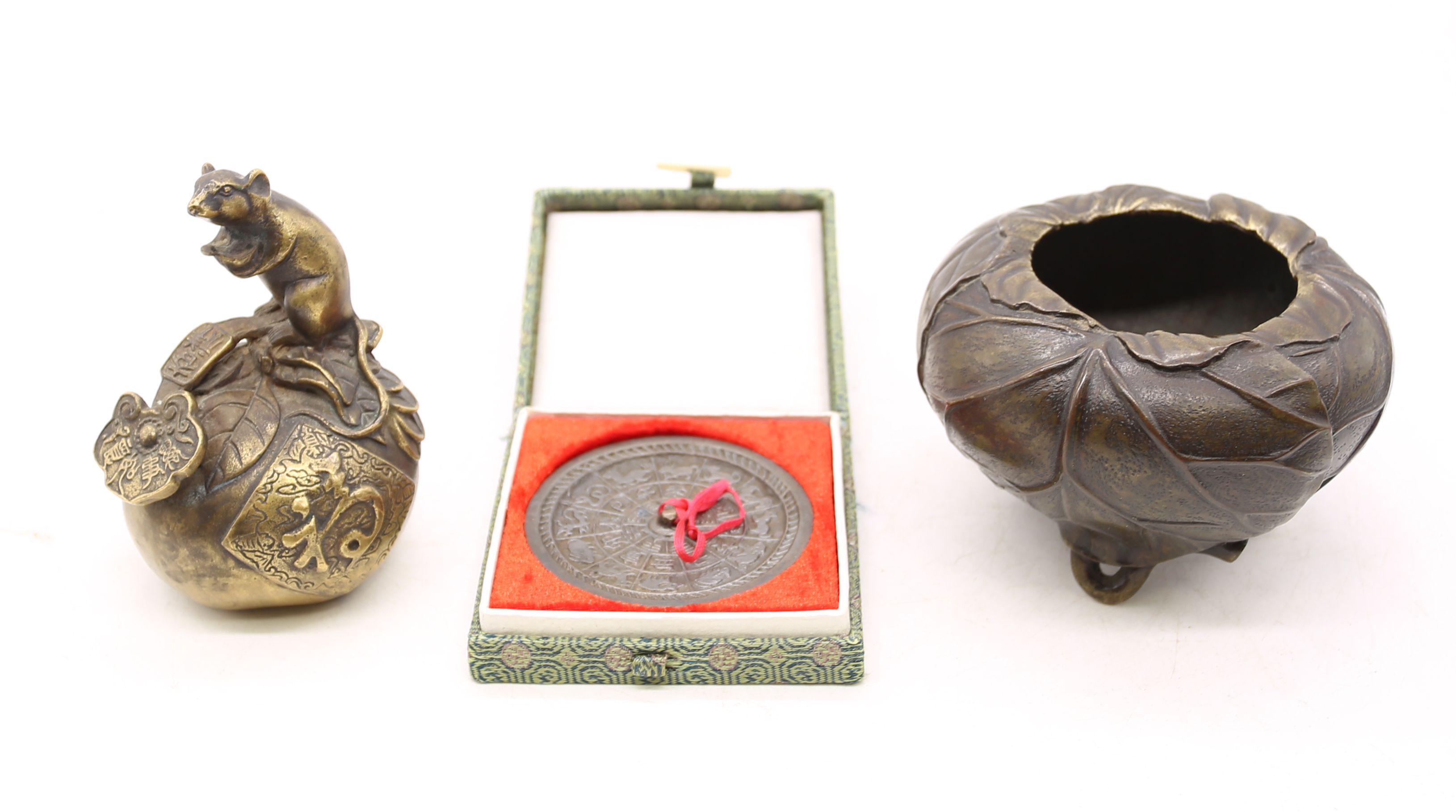 Oriental bronze items comprising a figural rat on a peach, tripod incense bowl decorated with