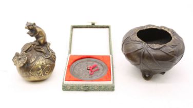 Oriental bronze items comprising a figural rat on a peach, tripod incense bowl decorated with