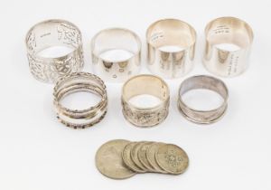 A collection of  five early 20th Century silver napkin rings, various designs, dates and makers,