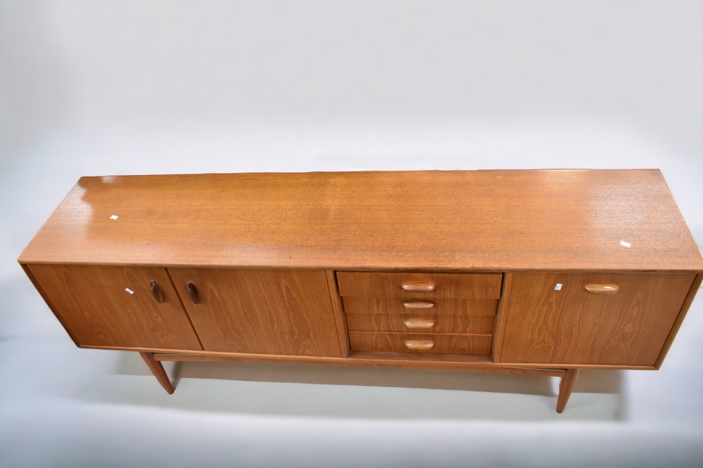 A mid 1970s teak G plan sideboard with three opening cupboard doors and four drawers, 206cm L x 46cm - Image 2 of 4