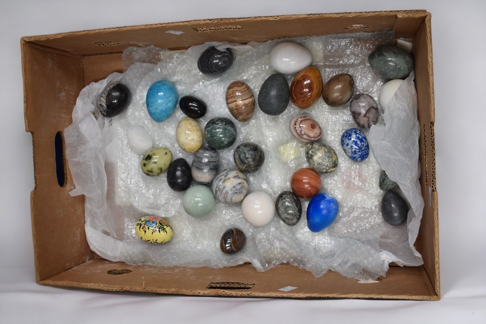A collection of various stone eggs and spheres to include marble, agate, amazonite, leopard stone,