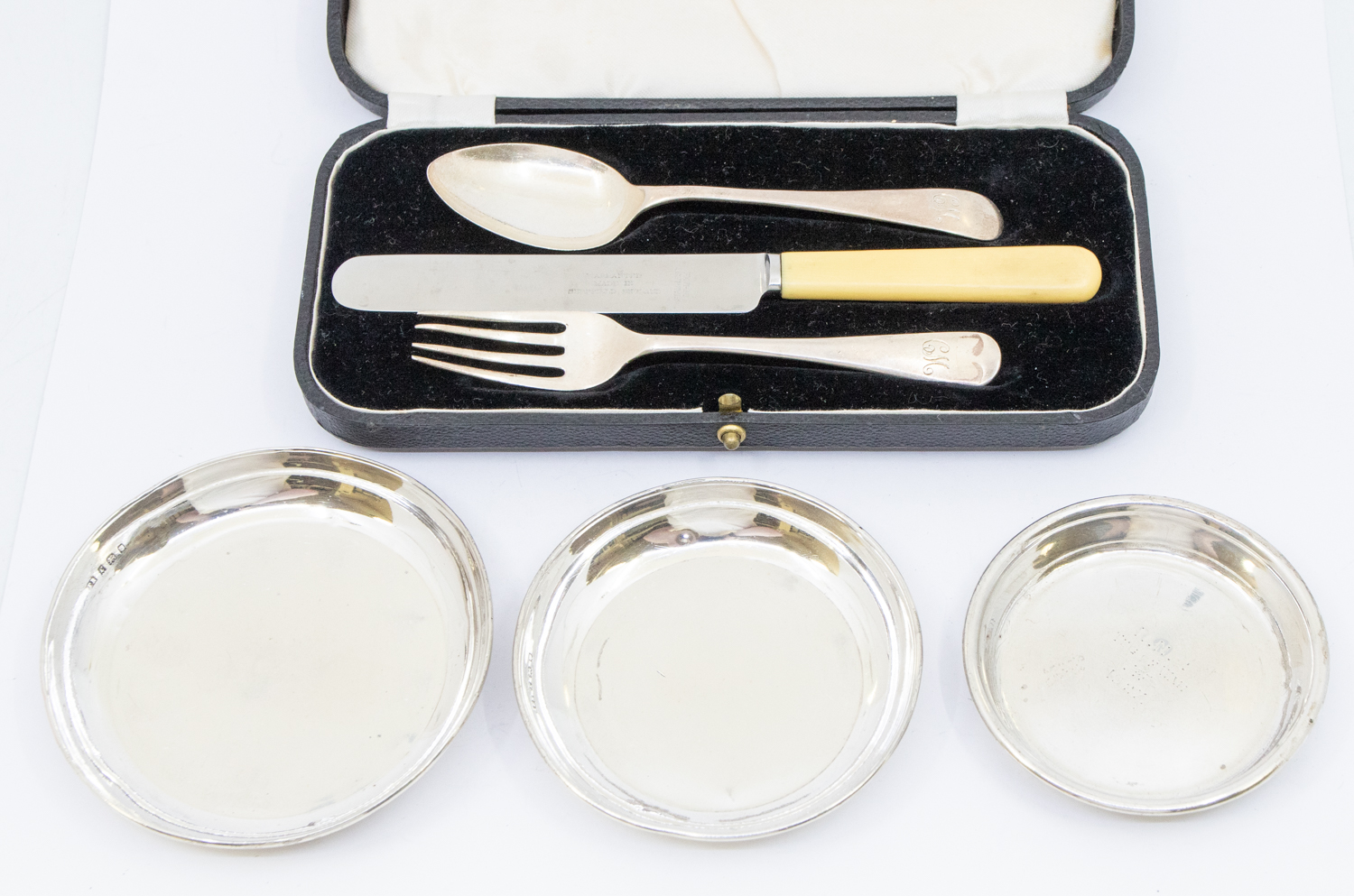 A set of three early 20th Century matched silver circular graduating small dishes, hallmarked