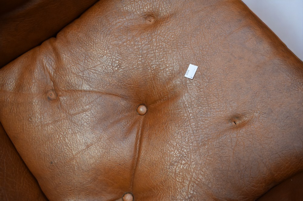 An early 1970s teak and leatherette button back lounge armchair on castors. - Image 5 of 6