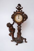 An early 20th century French spelter mantel clock with putti detail.