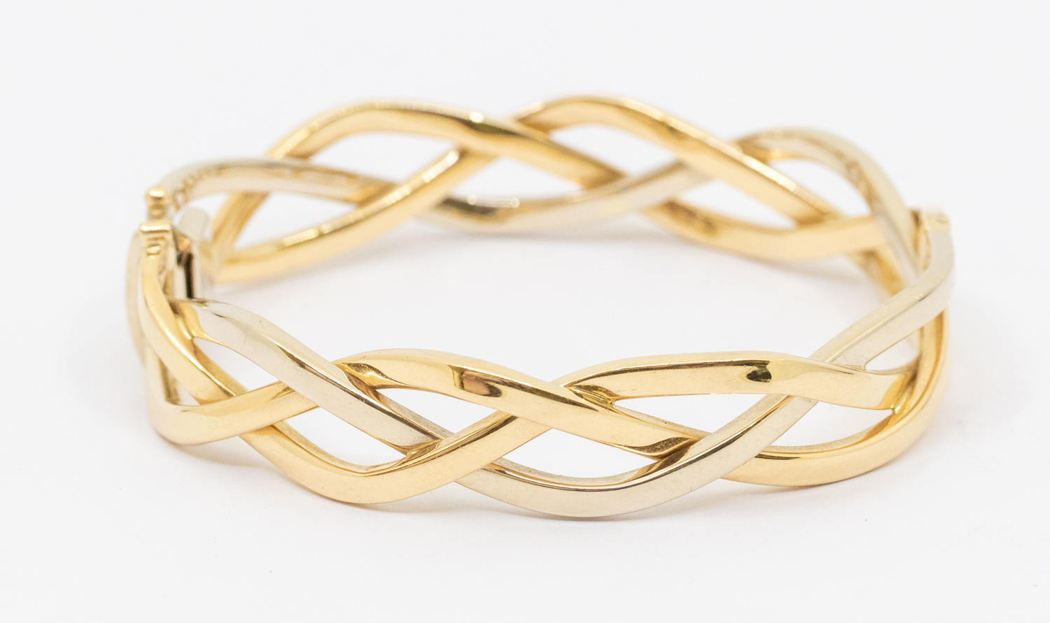An 18ct gold two tone hinged bangle, comprising wave link entwined wire details, width approx