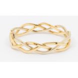 An 18ct gold two tone hinged bangle, comprising wave link entwined wire details, width approx