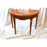 A George III half round mahogany card table.