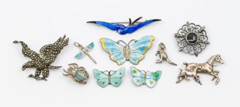 A collection of silver and enamel brooches including two small butterfly's along with a larger