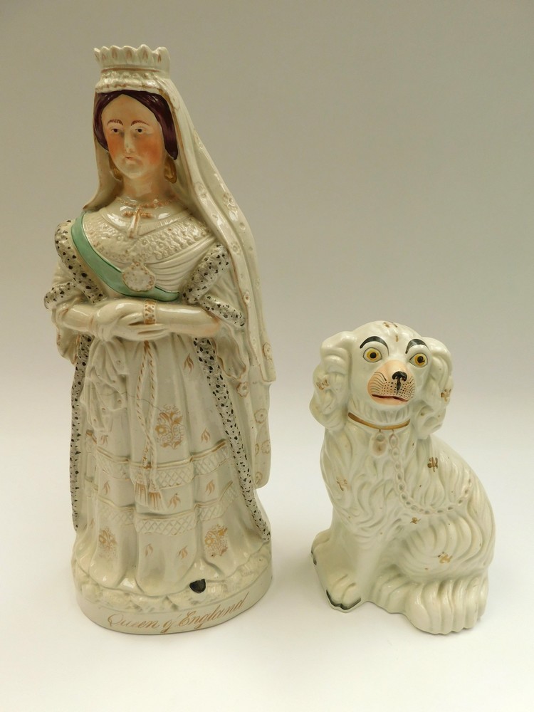 A Staffordshire figure of an early Victoria along with a Staffordshire dog, figure cracked