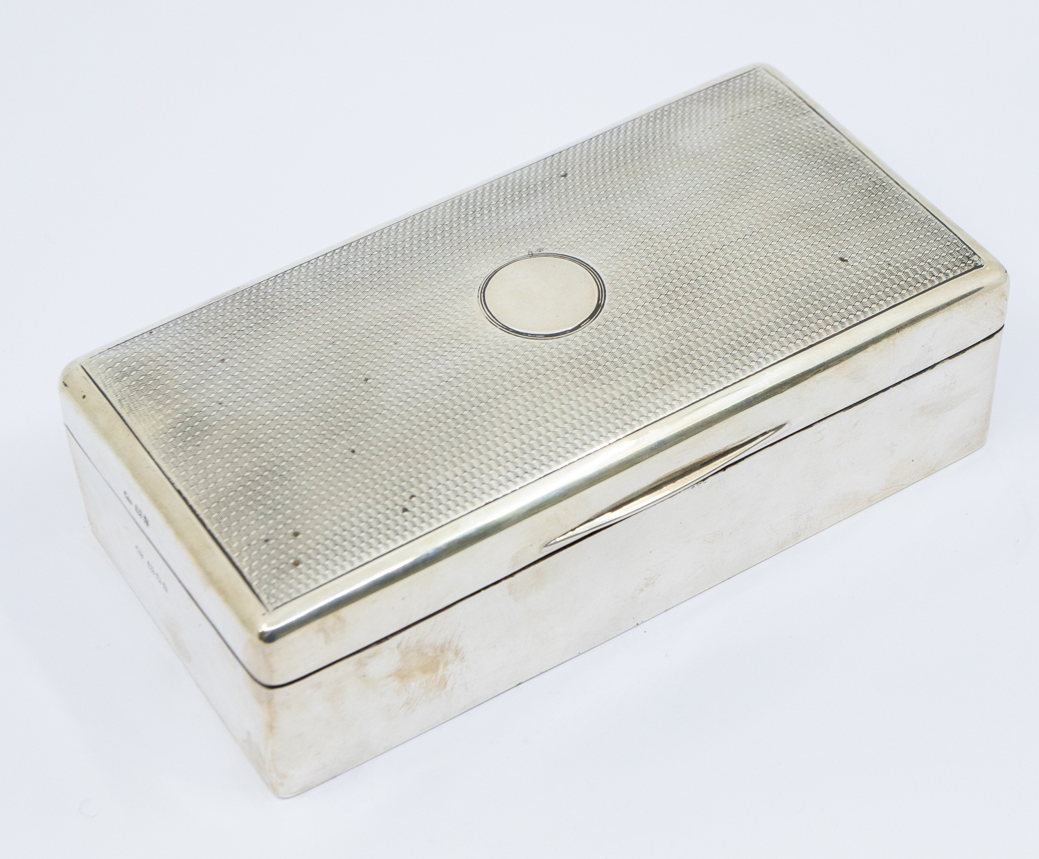 A George V rectangular silver cigarette box, engine turned decoration to cover, cedarwood interior