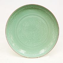 A modern Longquan style celadon carved dish, the centre with four claw dragon, the raised border