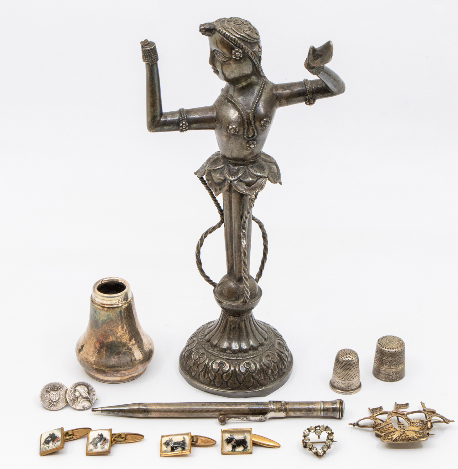A small collection of silver and jewellery to include; a tall Eastern figural sculpture, ornately