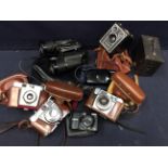 A collection of mid 20th Century cased cameras and a pair of binoculars.