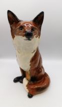 Beswick - A fireside Fox, circular factory mark to the base.