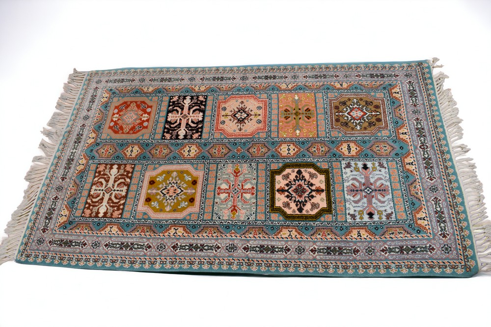 A turquoise ground late 20th Century Turkish rug with decorative floral designs, 195cm x 117cm.