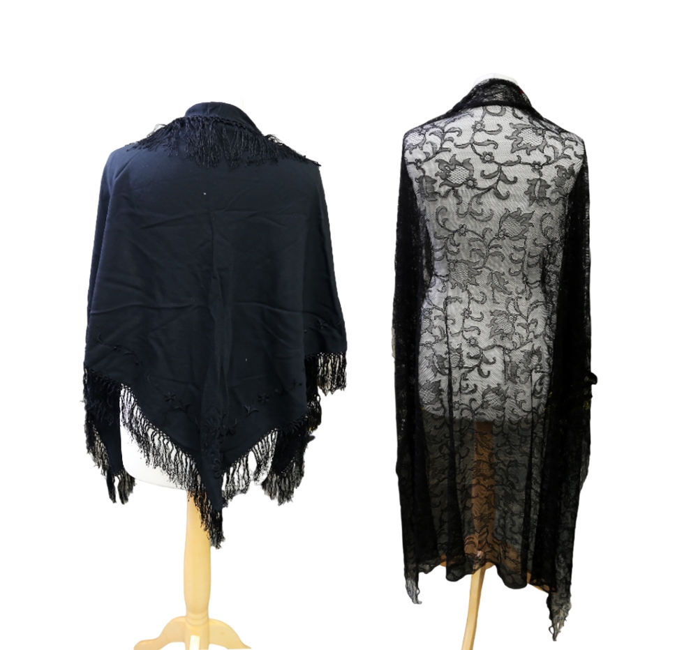 A black silk mowry shawl, early 1900s, embroidered corner and silk tassels (some holes), a black