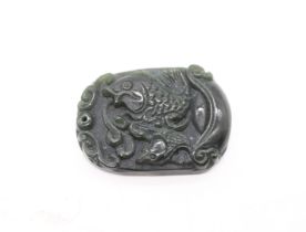 Serpentine/ nephrite jade pendant tablet depicting carp among waves. Size approx 4.5cm x 3.4cm x 1cm