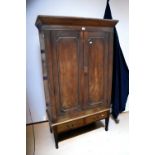 A George III mahogany hall cupboard on stand, two front opening doors to reveal shelf and storage