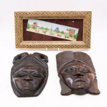 A hand painted picture of Indians playing polo, framed along with two carved African masks.