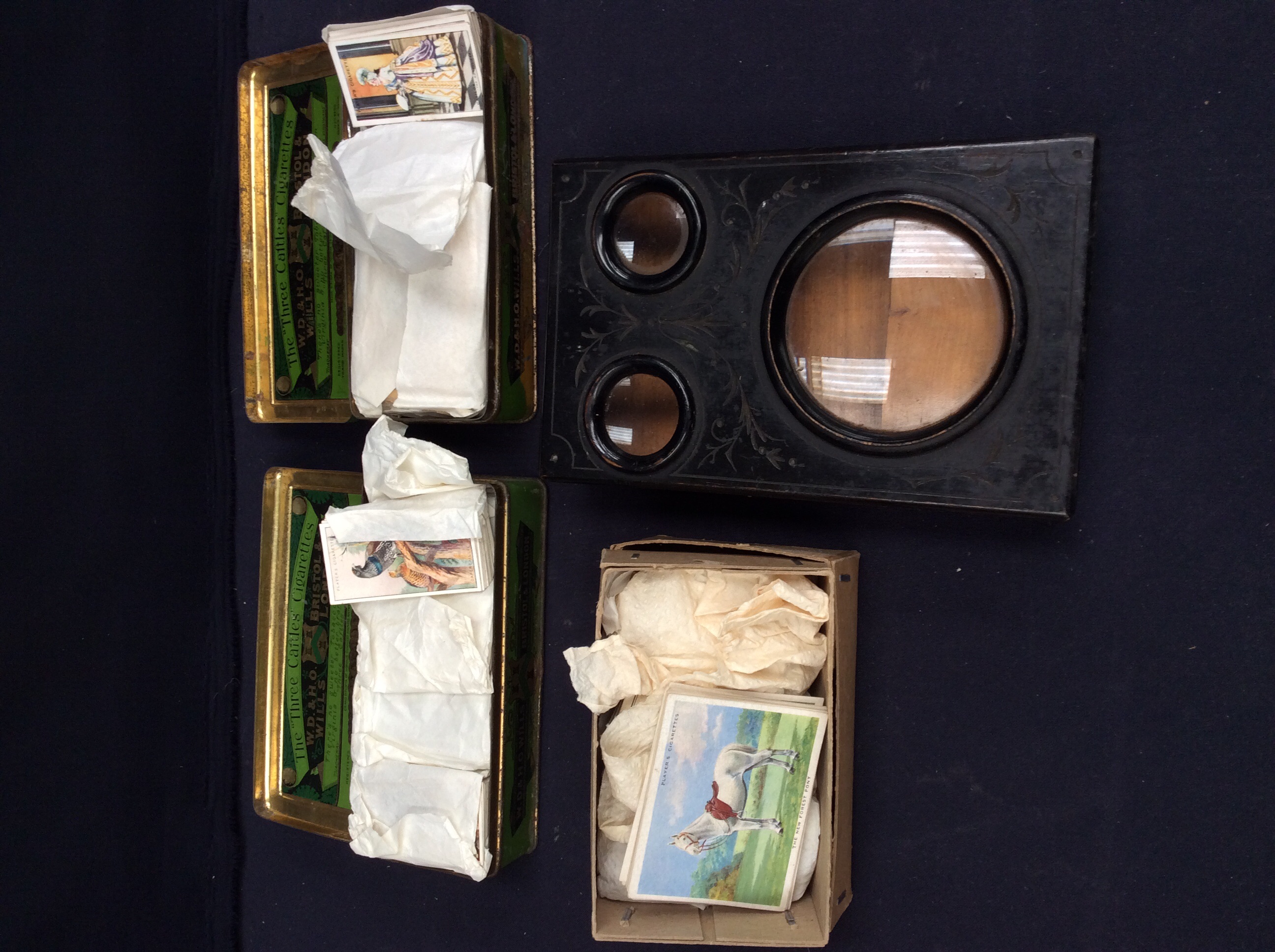 A vintage stereograph with stills and a collection of 1920s and 1930s cigarette cards.
