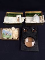 A vintage stereograph with stills and a collection of 1920s and 1930s cigarette cards.