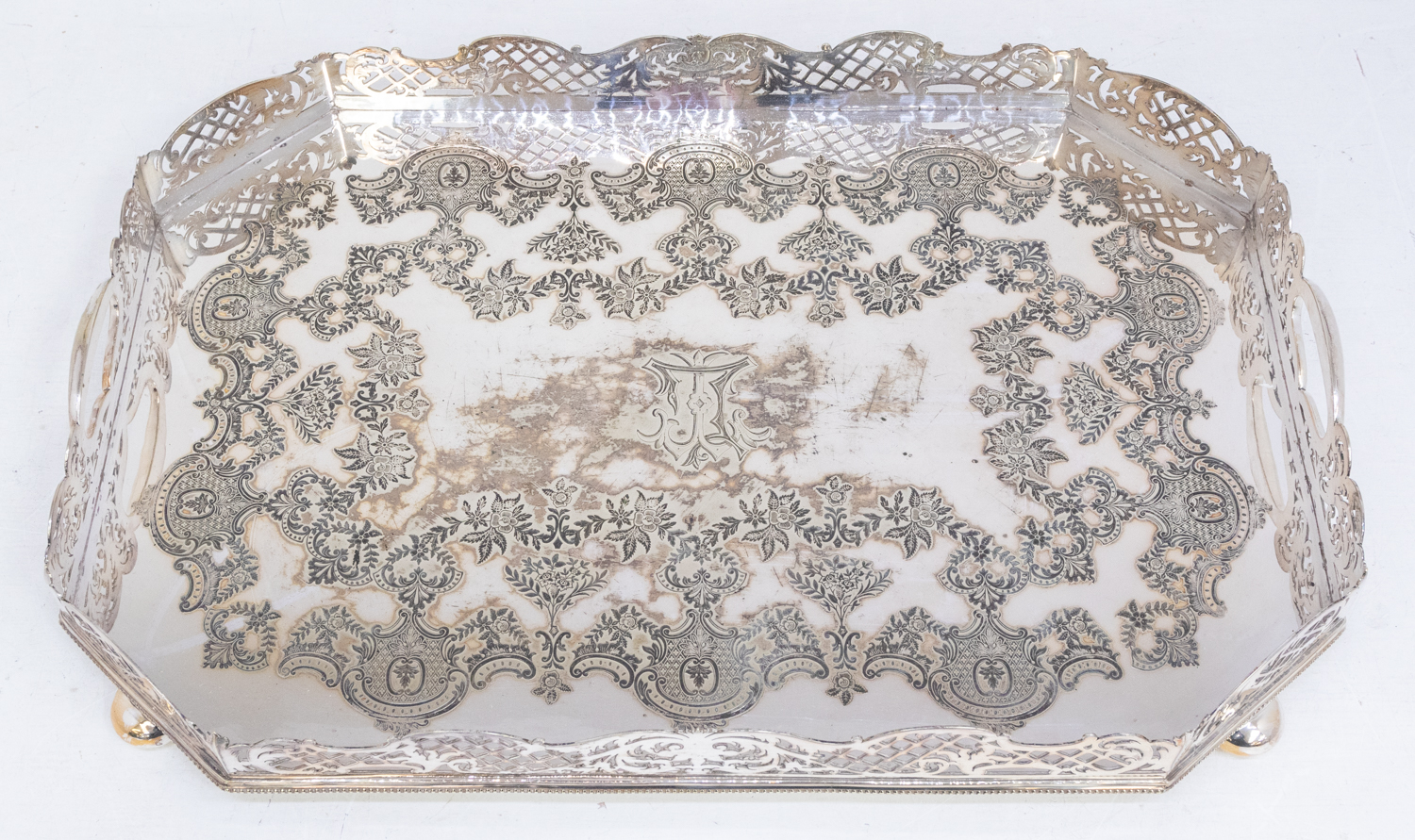 A large late 19th century/early 20th century silver plated serving tray with gallery surround and