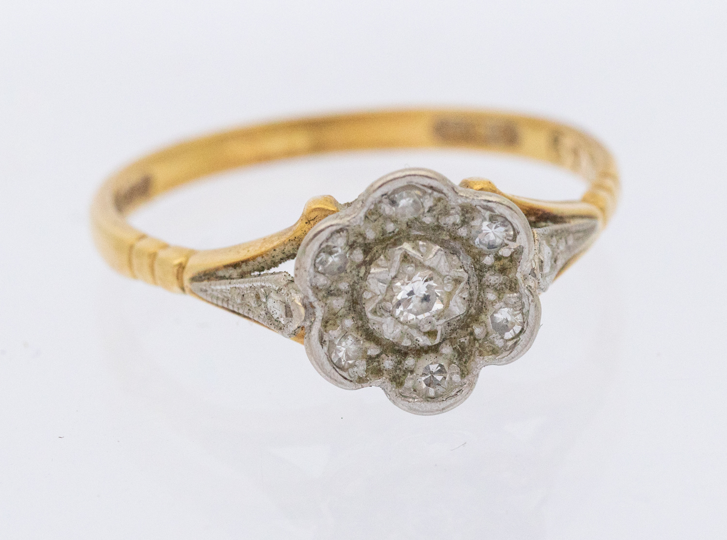 A diamond and 18ct gold cluster ring, flower cluster grain set with small diamonds, width approx